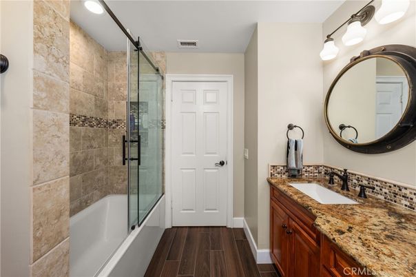 Bathroom, Dual Sink Vanities, Glass Shower, Interior, Recessed Lighting, Stone Walls, Wood Texture Flooring