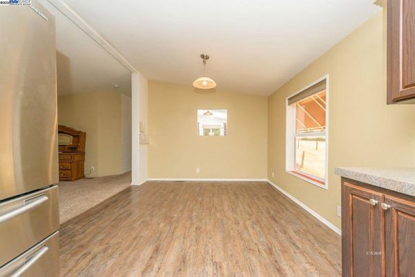 Empty room, Interior, Kitchen, Pendant Lights, Stainless Steel Appliances, Wood Texture Flooring