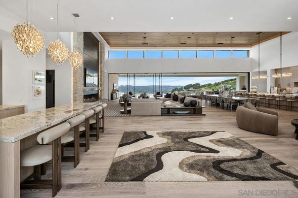 Chandelier, Dining room, Fireplace, Interior, Living room, Pendant Lights, Recessed Lighting, Water, Wooden Ceilings, Wood Texture Flooring, Wooden Walls