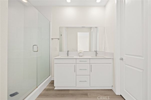 Bathroom, Dual Sink Vanities, Glass Shower, Interior, Recessed Lighting, Wood Texture Flooring