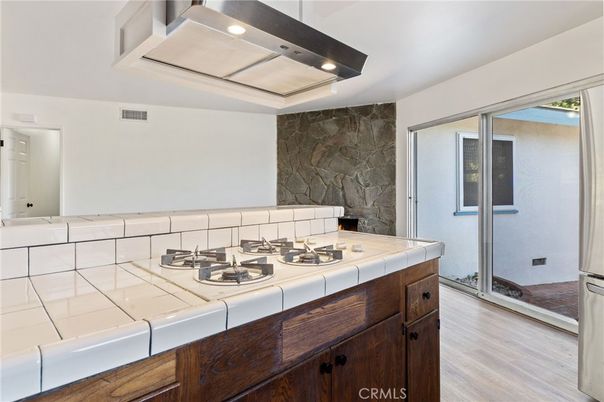 Interior, Kitchen, Recessed Lighting, Stone Walls, Tile Countertops, Wood Texture Flooring