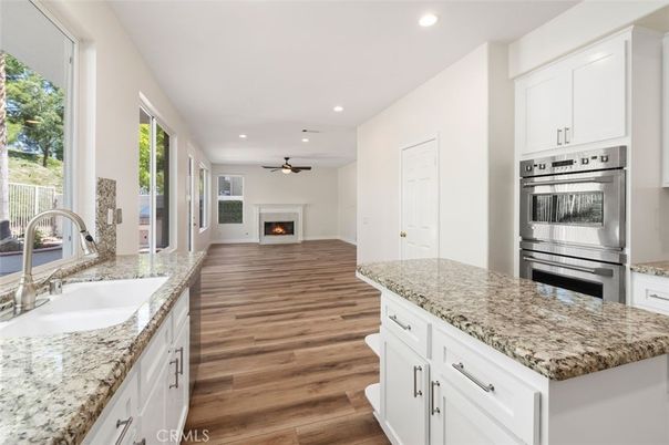 Fireplace, Interior, Kitchen, Recessed Lighting, Stainless Steel Appliances, Wood Texture Flooring