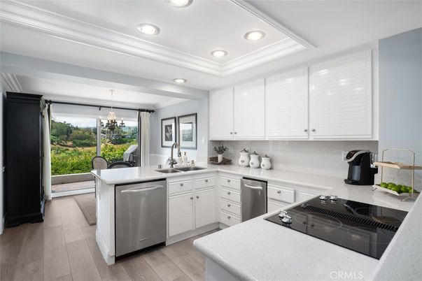 Chandelier, Dining room, Interior, Kitchen, Recessed Lighting, Stainless Steel Appliances, Wood Texture Flooring