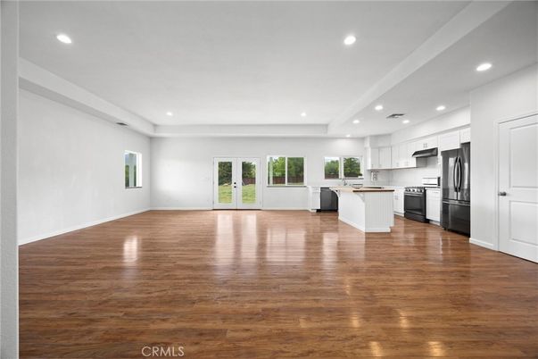 Empty room, Interior, Kitchen, Recessed Lighting, Stainless Steel Appliances, Wood Texture Flooring