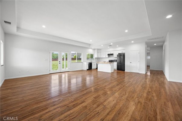 Empty room, Interior, Kitchen, Recessed Lighting, Stainless Steel Appliances, Wood Texture Flooring