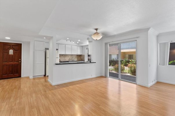 Empty room, Interior, Kitchen, Recessed Lighting, Stainless Steel Appliances, Wood Texture Flooring