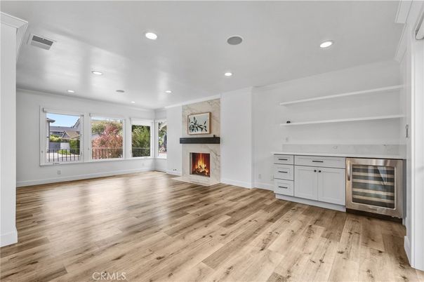 Empty room, Fireplace, Interior, Recessed Lighting, Stainless Steel Appliances, Wood Texture Flooring