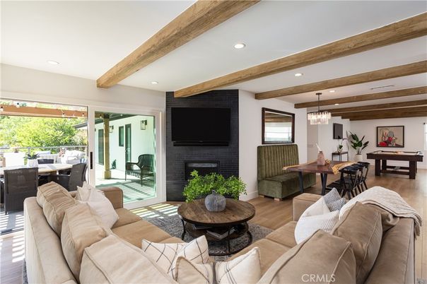 Billiard Table, Chandelier, Dining room, Fireplace, Game Room, Interior, Living room, Pendant Lights, Recessed Lighting, Wooden Beams, Wood Texture Flooring