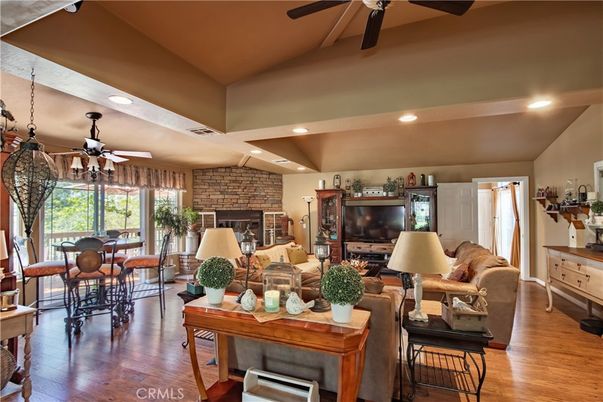 Dining room, Fireplace, Interior, Living room, Recessed Lighting, Stone Walls, Wood Texture Flooring