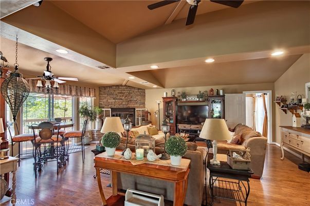 Dining room, Fireplace, Interior, Living room, Recessed Lighting, Stone Walls, Wood Texture Flooring