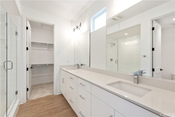Bathroom, Dual Sink Vanities, Glass Shower, Interior, Recessed Lighting, Walk-in Closets, Wood Texture Flooring