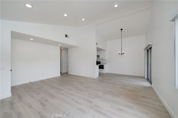 Empty room, Interior, Kitchen, Pendant Lights, Recessed Lighting, Stainless Steel Appliances, Wood Texture Flooring