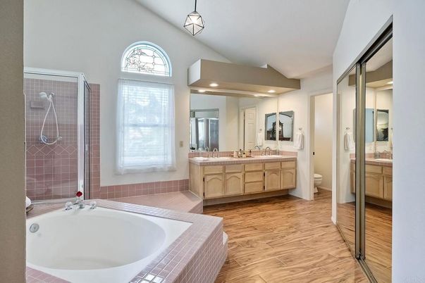 Bathroom, Dual Sink Vanities, Glass Shower, Interior, Pendant Lights, Recessed Lighting, Tile Countertops, Wood Texture Flooring