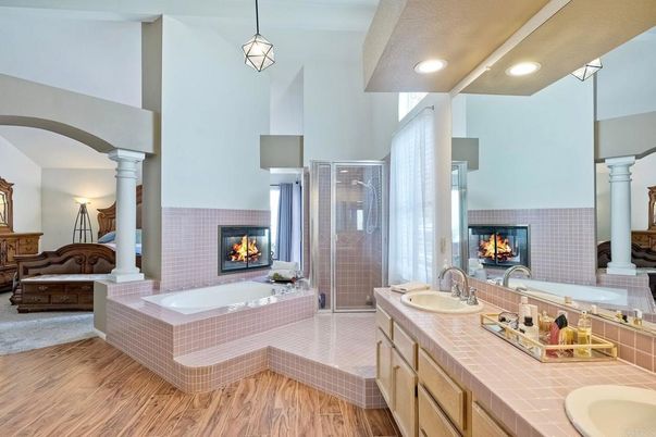 Bathroom, Dual Sink Vanities, Fireplace, Glass Shower, Interior, Pendant Lights, Recessed Lighting, Tile Countertops, Wood Texture Flooring