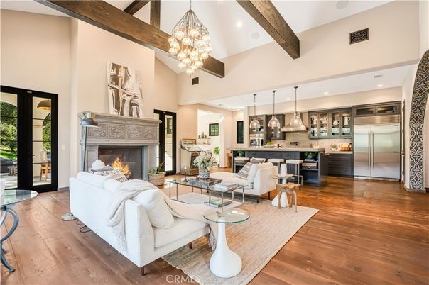 Chandelier, Fireplace, Interior, Kitchen, Living room, Pendant Lights, Recessed Lighting, Stainless Steel Appliances, Wooden Beams, Wood Texture Flooring