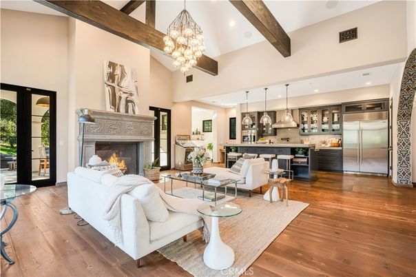 Chandelier, Fireplace, Interior, Kitchen, Living room, Pendant Lights, Recessed Lighting, Stainless Steel Appliances, Wooden Beams, Wood Texture Flooring
