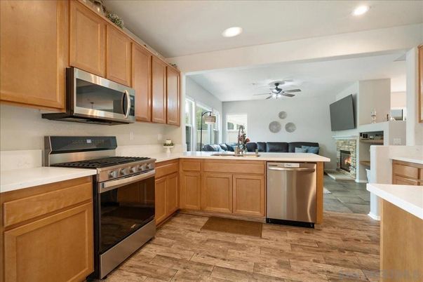 Fireplace, Interior, Kitchen, Recessed Lighting, Stainless Steel Appliances, Wood Texture Flooring