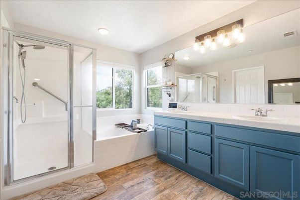 Bathroom, Dual Sink Vanities, Glass Shower, Interior, Recessed Lighting, Tile Countertops, Wood Texture Flooring