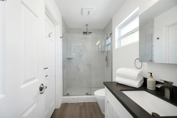 Bathroom, Glass Shower, Interior, Marble Walls, Wood Texture Flooring