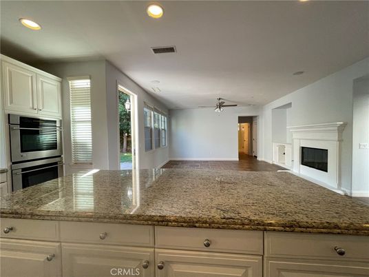 Fireplace, Interior, Kitchen, Recessed Lighting, Stainless Steel Appliances, Wood Texture Flooring