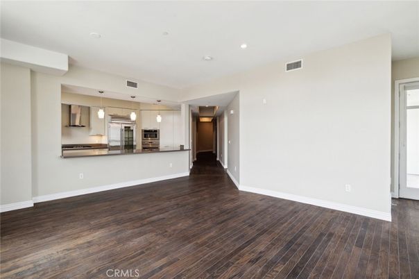 Empty room, Interior, Kitchen, Pendant Lights, Recessed Lighting, Stainless Steel Appliances, Wood Texture Flooring