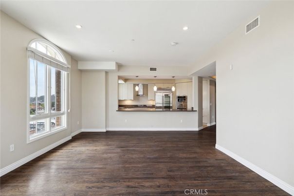 Empty room, Interior, Kitchen, Pendant Lights, Recessed Lighting, Stainless Steel Appliances, Wood Texture Flooring