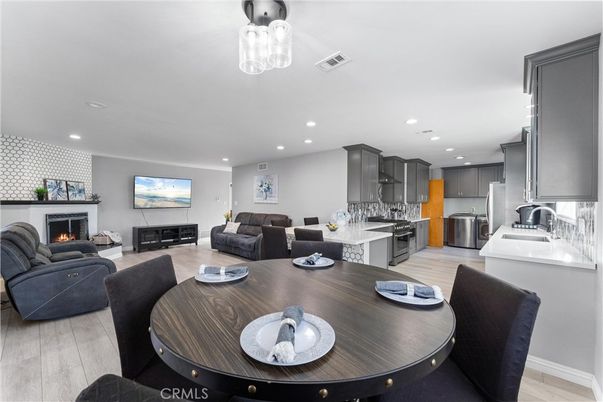 Dining room, Fireplace, Interior, Kitchen, Living room, Recessed Lighting, Stainless Steel Appliances, Wood Texture Flooring