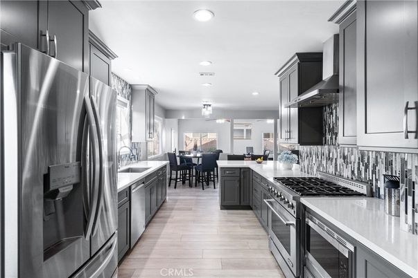 Chandelier, Dining room, Interior, Kitchen, Recessed Lighting, Stainless Steel Appliances, Wood Texture Flooring