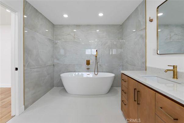 Bathroom, Dual Sink Vanities, Free Standing Baths, Interior, Marble Walls, Recessed Lighting, Wood Texture Flooring