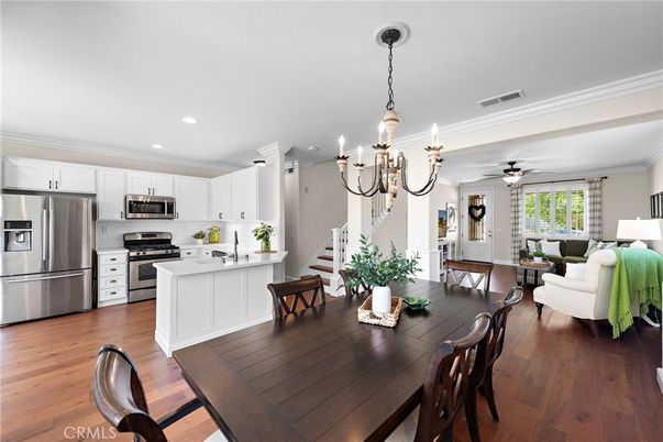 Chandelier, Dining room, Interior, Kitchen, Living room, Pendant Lights, Recessed Lighting, Stainless Steel Appliances, Wood Texture Flooring