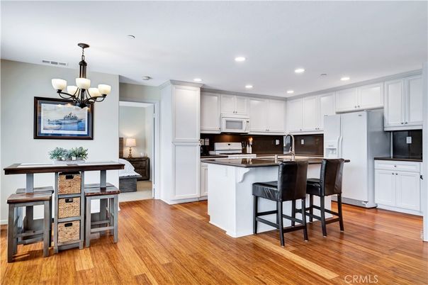 Chandelier, Dining room, Interior, Kitchen, Recessed Lighting, Stainless Steel Appliances, Wood Texture Flooring