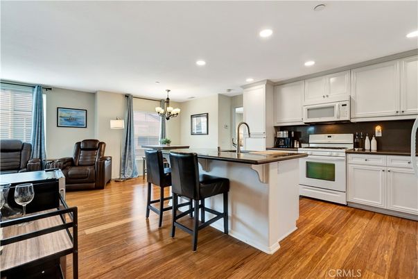 Chandelier, Dining room, Interior, Kitchen, Recessed Lighting, Stainless Steel Appliances, Wood Texture Flooring