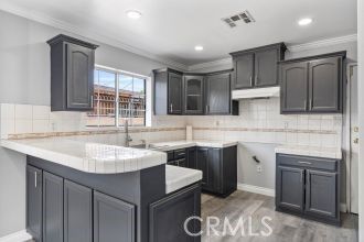 Interior, Kitchen, Recessed Lighting, Tile Countertops, Wood Texture Flooring