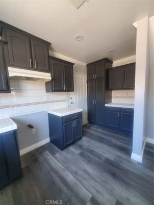 Interior, Kitchen, Recessed Lighting, Tile Countertops, Wood Texture Flooring