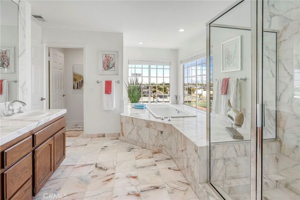 Bathroom, Dual Sink Vanities, Glass Shower, Interior, Marble, Marble Walls, Recessed Lighting, Tile Countertops