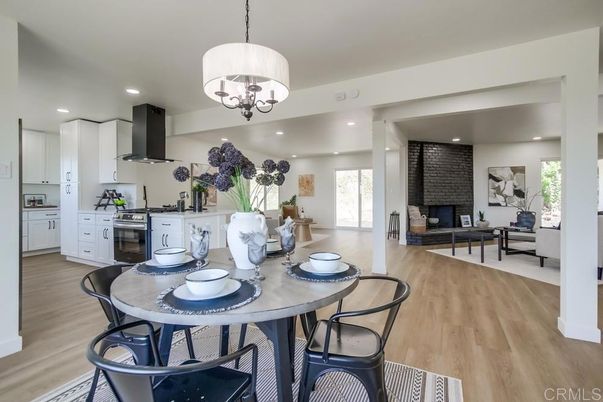 Chandelier, Dining room, Fireplace, Interior, Kitchen, Living room, Pendant Lights, Recessed Lighting, Stone Walls, Wood Texture Flooring