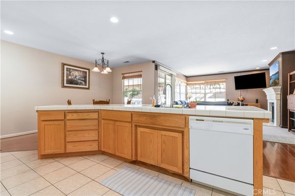 Fireplace, Interior, Kitchen, Pendant Lights, Recessed Lighting, Tile Countertops, Wood Texture Flooring