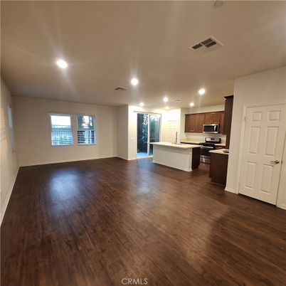 Empty room, Interior, Kitchen, Recessed Lighting, Stainless Steel Appliances, Wood Texture Flooring