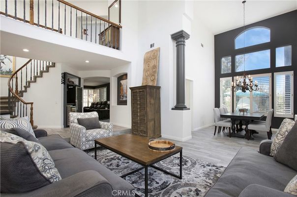 Chandelier, Dining room, Fireplace, Interior, Living room, Recessed Lighting, Water, Wood Texture Flooring