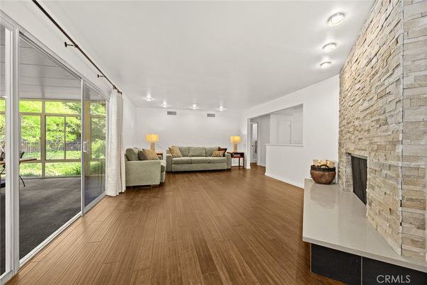 Fireplace, Interior, Living room, Recessed Lighting, Stone Walls, Wood Texture Flooring
