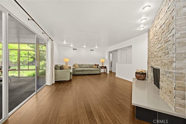 Fireplace, Interior, Living room, Recessed Lighting, Stone Walls, Wood Texture Flooring
