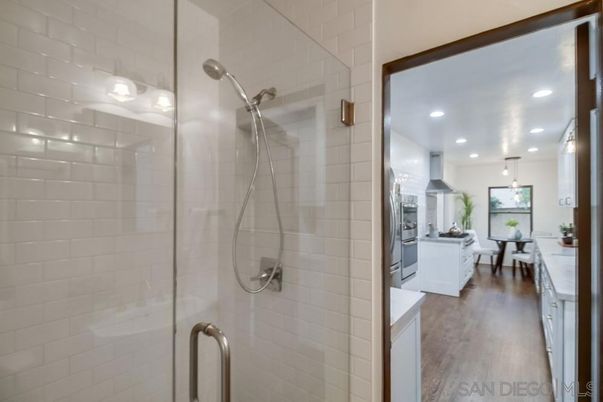 Bathroom, Dining room, Glass Shower, Interior, Kitchen, Pendant Lights, Recessed Lighting, Stainless Steel Appliances, Wood Texture Flooring