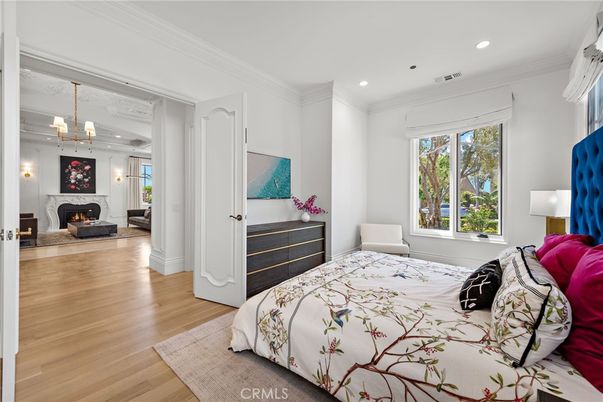 Bedroom, Chandelier, Fireplace, Interior, Recessed Lighting, Wood Texture Flooring