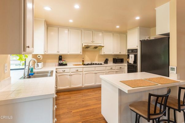 Interior, Kitchen, Recessed Lighting, Tile Countertops, Wood Texture Flooring