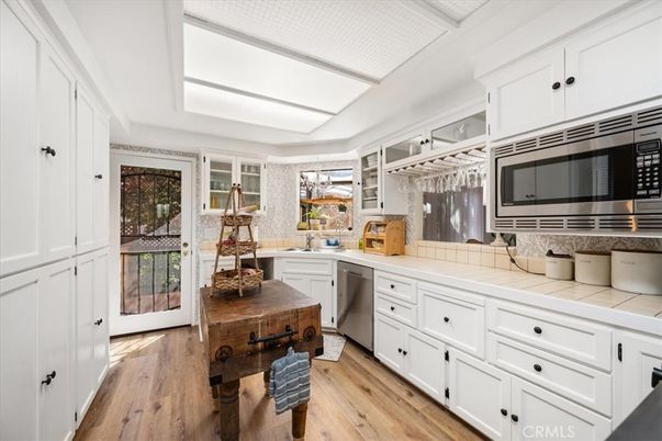 Interior, Kitchen, Stainless Steel Appliances, Tile Countertops, Wood Texture Flooring