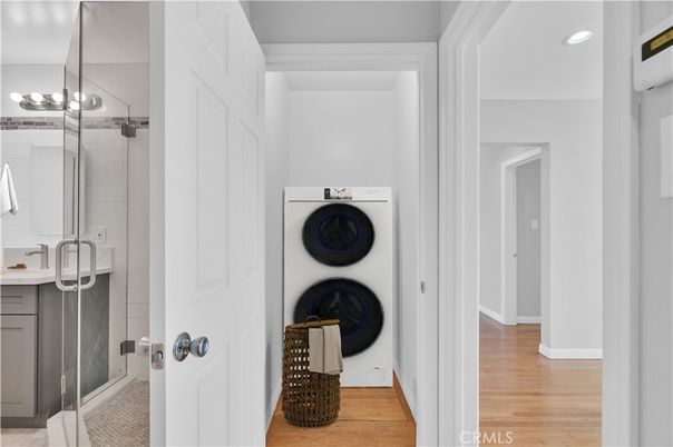 Bathroom, Glass Shower, Interior, Recessed Lighting, Washer, Wood Texture Flooring