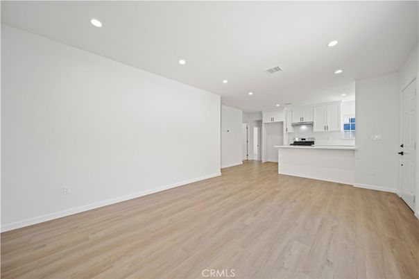 Empty room, Interior, Kitchen, Recessed Lighting, Stainless Steel Appliances, Wood Texture Flooring