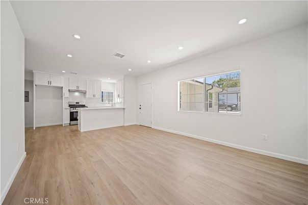 Empty room, Interior, Kitchen, Recessed Lighting, Stainless Steel Appliances, Wood Texture Flooring