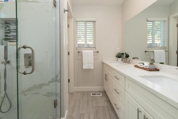 Bathroom, Dual Sink Vanities, Glass Shower, Interior, Marble Walls, Wood Texture Flooring