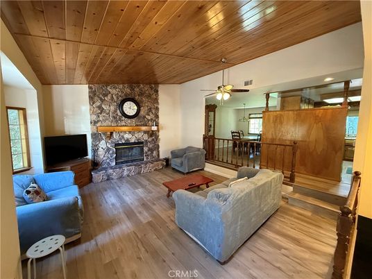 Dining room, Fireplace, Interior, Living room, Recessed Lighting, Stone Walls, Wooden Ceilings, Wood Texture Flooring